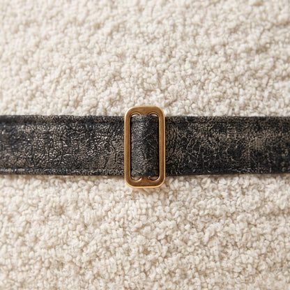 Close-up of Dream Cloud ivory texture, black trim and bronze buckle
