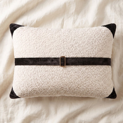 White bouclé lumbar pillow cover with black printed velvet banding, corner accents and bronze-tone buckle hardware.
