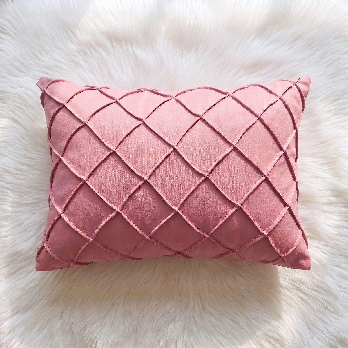 Dusty rose velvet lumbar pillow cover with raised handwoven geometric lattice detailing across the front.
