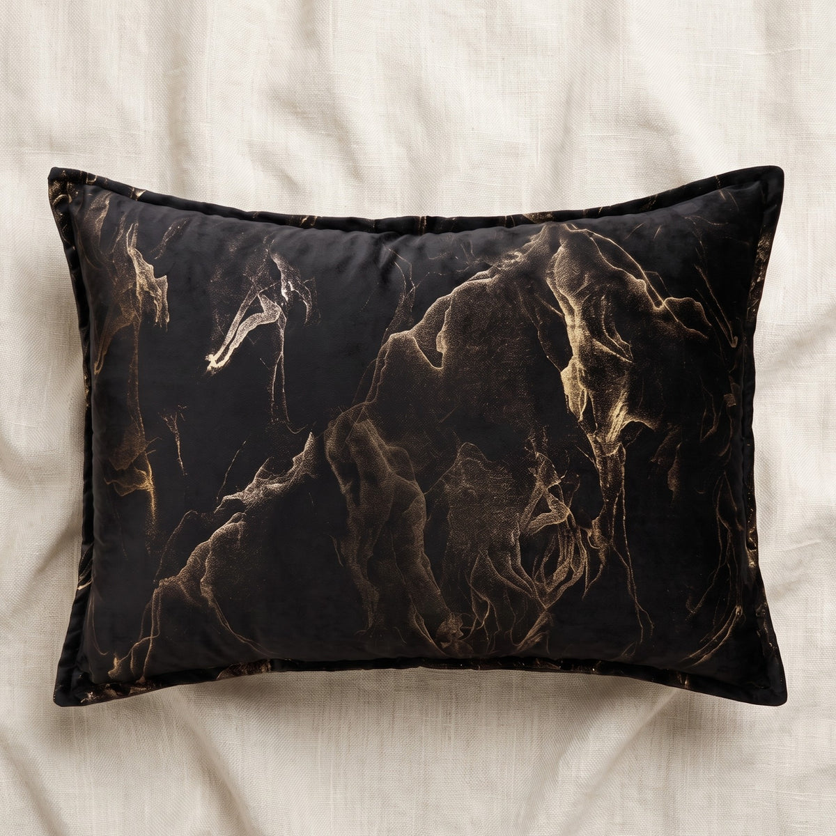 Rectangular black velvet lumbar pillow cover featuring a flowing gold abstract smoke pattern and coordinating piped border.
