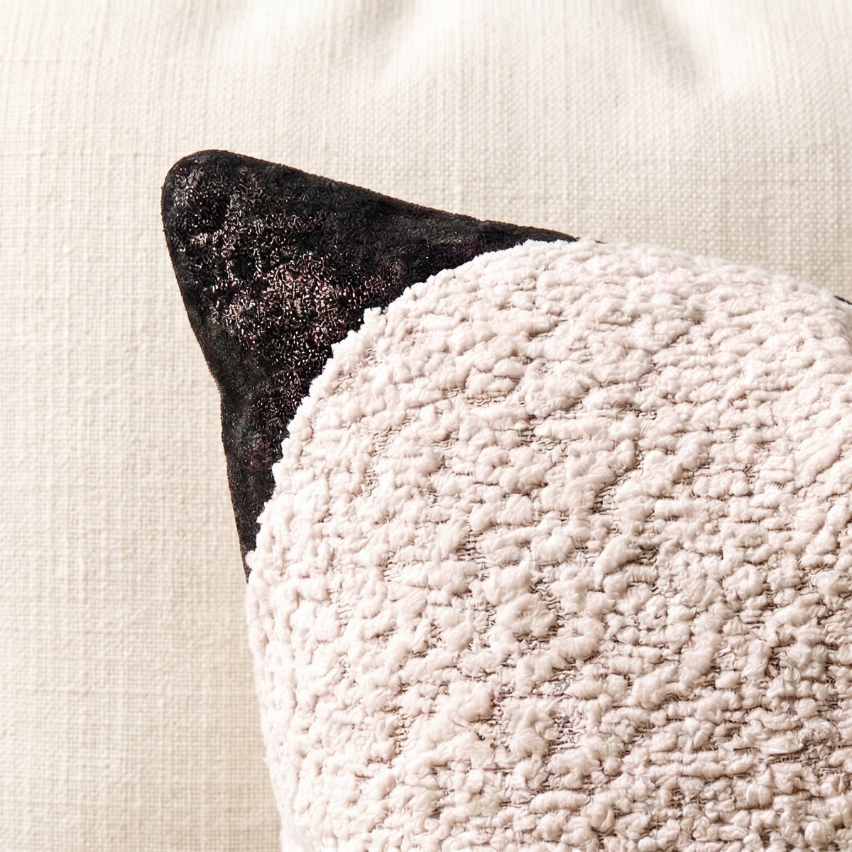 White bouclé lumbar pillow cover with black printed velvet banding, corner accents and bronze-tone buckle hardware.