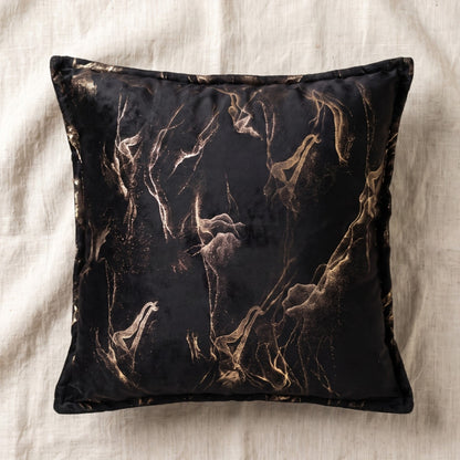 Square black printed velvet pillow cover with gold abstract smoke pattern and coordinating edge detailing.
