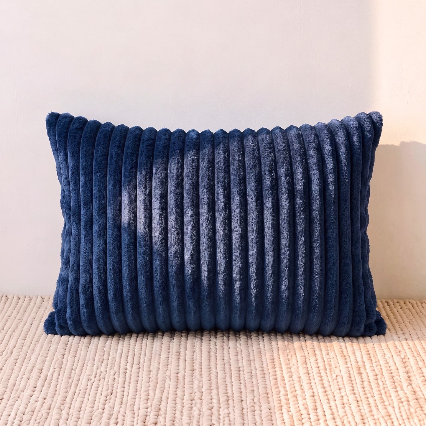 Rectangular navy blue corduroy lumbar pillow cover with deep vertical ribbing across the front.

