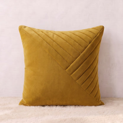 Mustard-gold square velvet pillow cover with layered diagonal pleated panels forming a geometric design.