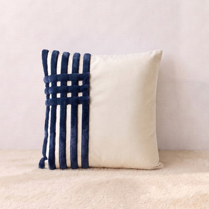 Ivory velvet square pillow cover with navy corduroy bands arranged in a structured linear design.
