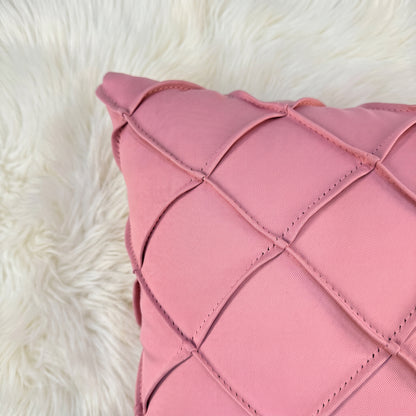 Close-up of dusty rose velvet showing the handwoven lattice bands, stitching and dimensional geometric texture.
