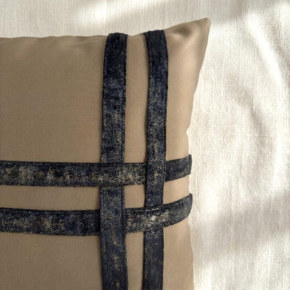 Close-up of dark bronze-toned printed velvet bands stitched over soft taupe velvet, showing the contrasting textures and pattern.