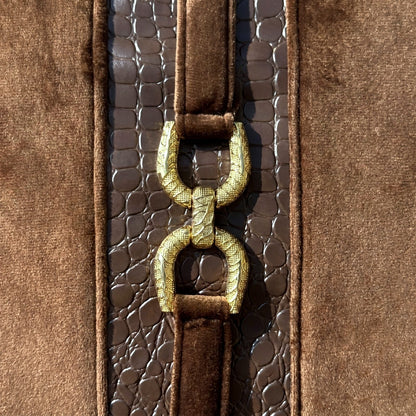 Close-up of Mocha Crest gold-tone decorative hardware and dark brown croc-embossed faux leather