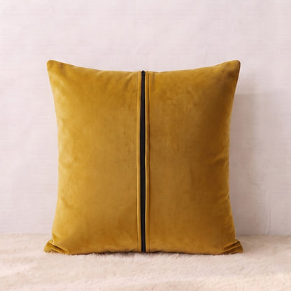 Back of a mustard-gold velvet pillow cover showing the plain velvet reverse and zipper closure.
