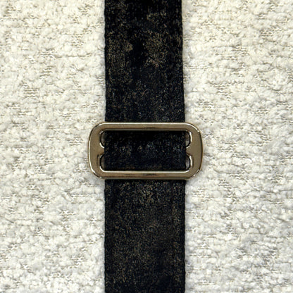 Close-up of Dream Cloud white texture, black trim and bronze buckle