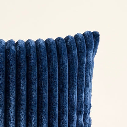 Close-up of navy corduroy fabric showing the soft raised ribs, pile direction and textured surface.