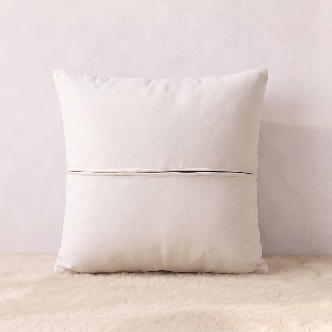 Back view of an ivory velvet pillow cover showing the plain velvet reverse and zipper closure.

