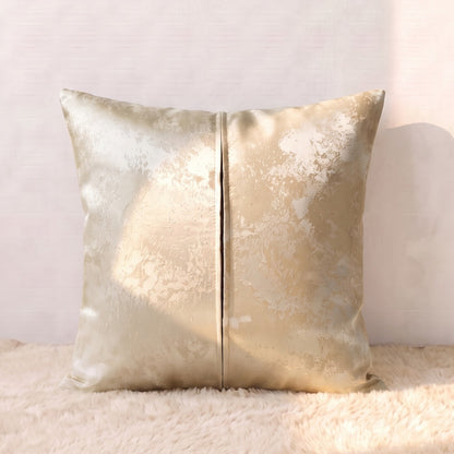 Back of a champagne-gold jacquard square pillow cover showing the matching patterned fabric and zipper closure.