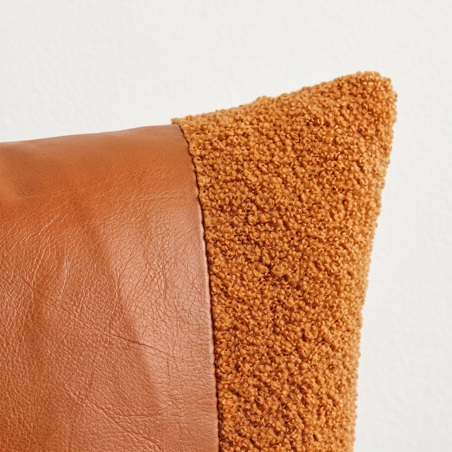 Close-up of Rustic Amber orange texture, brown PU leather and stitching
